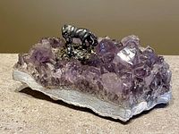 Full view of amethyst cluster with metal horse and foal sculpture