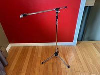 Full view of Apex chrome microphone stand with boom arm extended horizontally