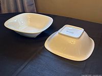 Two white square serving bowls, one upright one inverted showing interior/exterior