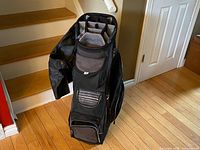 Full view of Callaway ORG 14 golf cart bag standing upright with rain cover draped at side