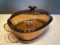 Pan with lid angled view showing amber glass and knob handle