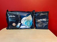 Sealed retail package alongside folded cover bag.