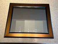 Front view of rectangular mirror showing full frame and glass