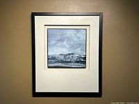 Full view of framed seascape painting on wall