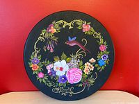 Front view of circular hand-painted wooden lazy Susan showing full floral and bird design