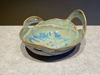 Top three-quarter view of bowl showing glaze colors, handle shape and overall design