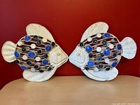 Two metal fish sculptures side by side showing overall design