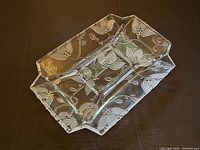 Top view of pressed glass platter showing floral pattern and three sections