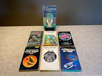 All seven paperback books laid out front covers visible