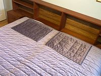 Comforter laid on bed showing quilted pattern and color