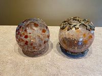 Two crackle glass orbs and one attached to plastic base