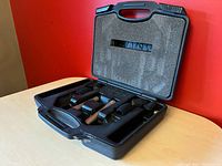 Open carry case showing two NT5 microphones, two mic clips and two foam windscreens in fitted foam insert