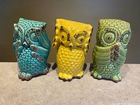 Front view of all three glazed ceramic owl figurines