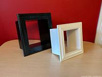 Black and white cube shelves side by side showing depth and finishes