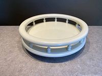 Top view showing round cream lazy Susan with balustrade edge