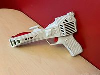Left side view of white Radio Shack Space Laser toy showing overall design and condition