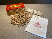 Full set laid out: painted box, tokens, card, bag