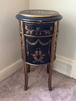 Front view of painted drum table showing drawer, cabinet door, leg design