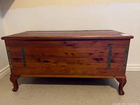 Front view of cedar chest showing lid, front panel, and legs