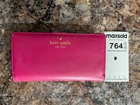 Front view showing hot pink leather exterior and gold logo