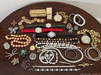 Group shot of entire costume jewelry lot spread on table