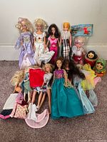 Group shot of all dolls, nesting dolls and clothing