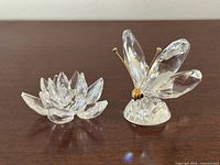 Butterfly and lotus figurines side by side