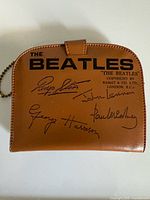 Full view of wallet exterior showing Beatles logo and signatures