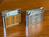 Front view of both Bentley lighters—wood veneer model and textured metal model