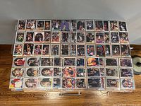 Overhead view of entire lot of basketball cards arranged in binder pages