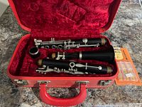 Clarinet disassembled in red case with reed pack