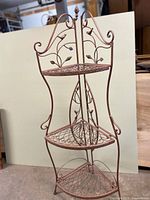 Full view of copper metal 3-tier plant stand folded open