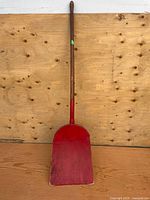 Full view of red wooden shovel front