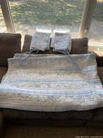 Quilt and two shams displayed on sofa