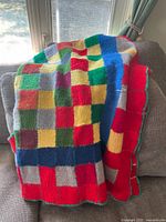 Afghan folded on sofa showing colour blocks and edge