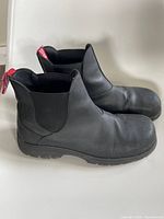 Full left side profile of both boots showing overall design and wear