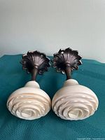 Front view showing rosette spiral ceramic fronts and metal bases