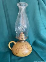 Full view assembled pottery base, brass burner, glass chimney