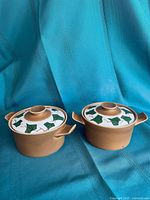 Pair of brown stoneware crocks with ivy-pattern lids
