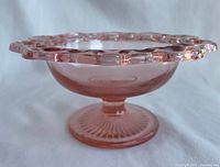 Side profile showing pedestal base and lace edge rim