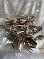 Bagged assortment of silver plated cutlery pieces