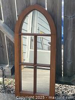 Front view of arched six-pane wood frame mirror