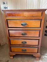 Front view of nightstand showing four drawers and hardware