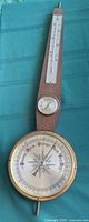 Front view of wood banjo-style weather station showing barometer, thermometer, hygrometer