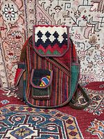 Front view showing kilim patterns, flap, and pocket