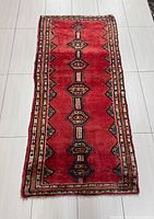 Full view of red Hamadan runner rug showing entire pattern and borders