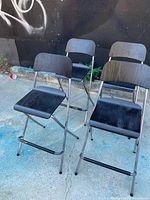 Group of four folding stools outdoor setting