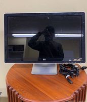 Front view of HP 2509b monitor on stand with cords