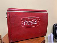 Full view of red metal Coca-Cola cooler closed