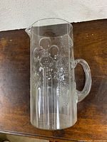 Full side view showing embossed pattern, handle and spout